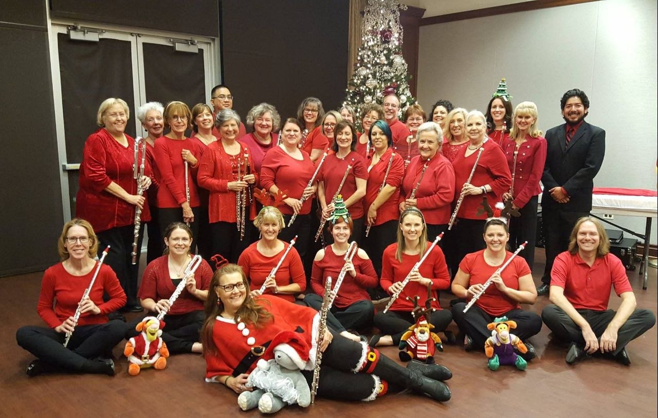 Flute choir gathered in red concert attire